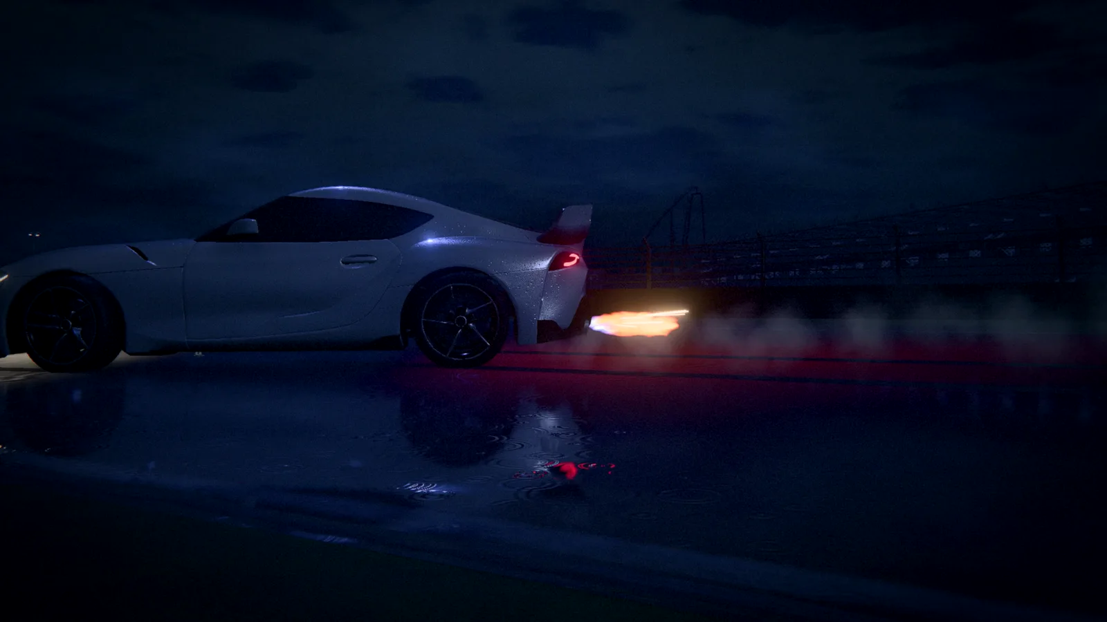 A white sports car with orange flames from the exhaust on a dark, wet circuit at night