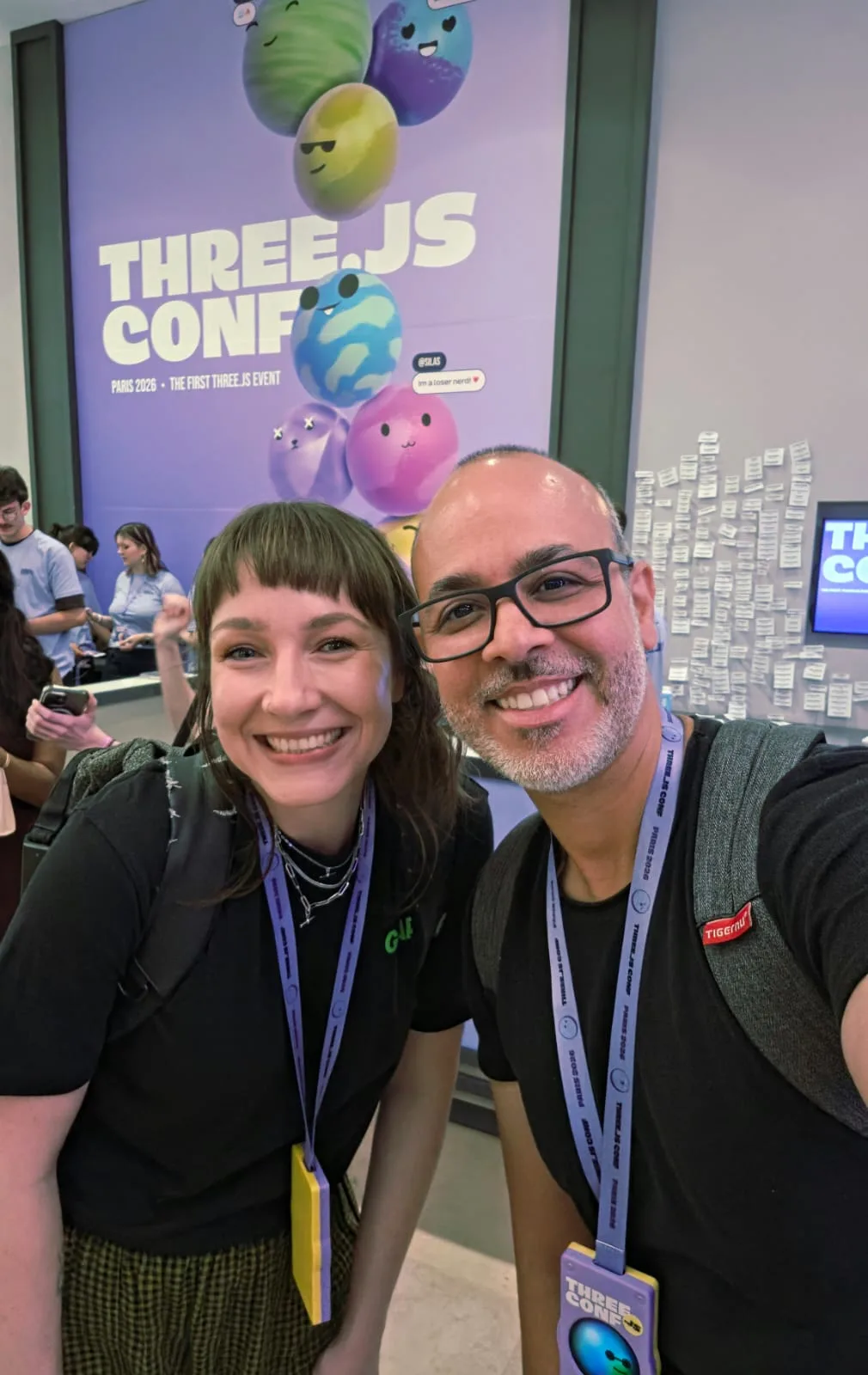 Me with a fellow attendee in front of the Three.js Conf Paris 2026 banner, both wearing conference lanyards